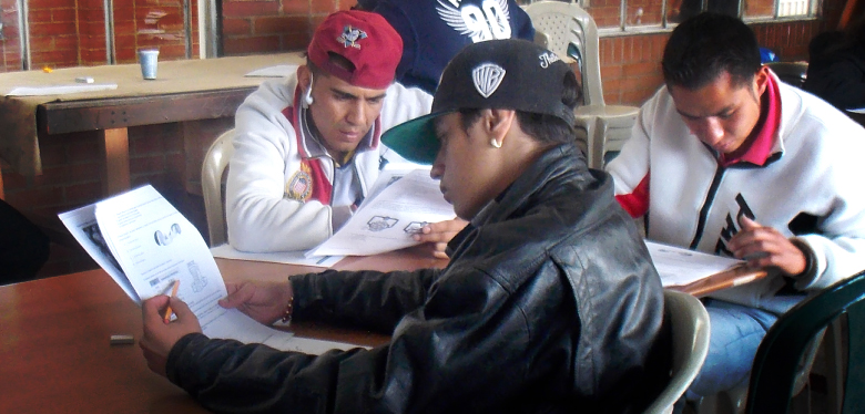 Jóvenes leyendo hojas en examen de convalidación